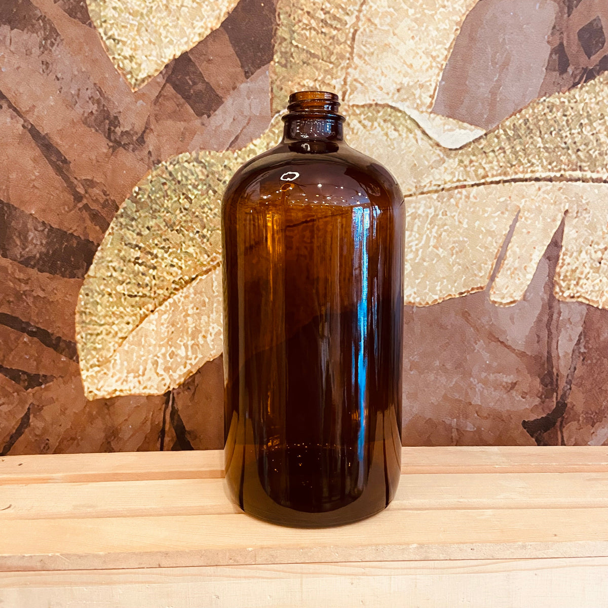 Amber glass Boston bottles in 32 oz, 16 oz, and 8 oz sizes by Premium Vials, shown in a clear image with caps and labels.