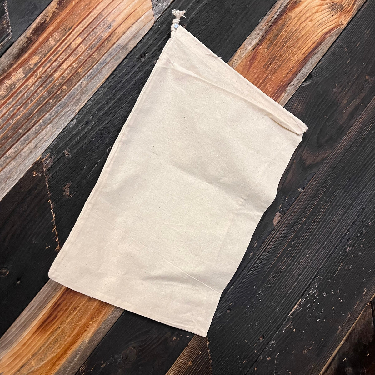 Cotton drawstring bag by OTB Refills in various sizes, showing the soft fabric and adjustable drawstring closure.