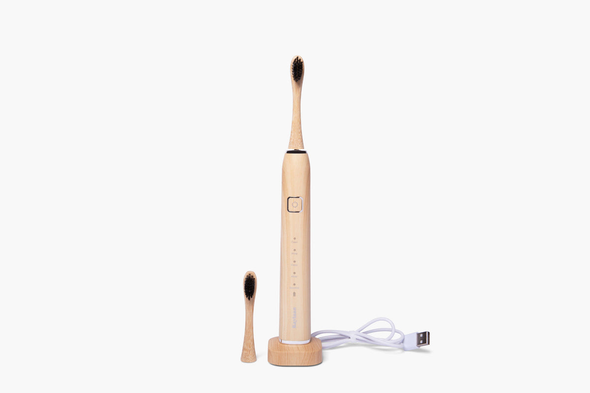 Kaylaan electric bamboo toothbrush with rechargeable design, featuring sleek bamboo handle and soft bristle brush head.