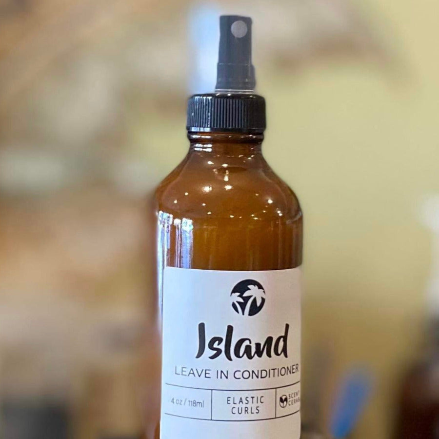 ScentCerae Leave-In Conditioner in a 4oz glass bottle, natural hair care product for moisture and shine, with island-inspired scent.