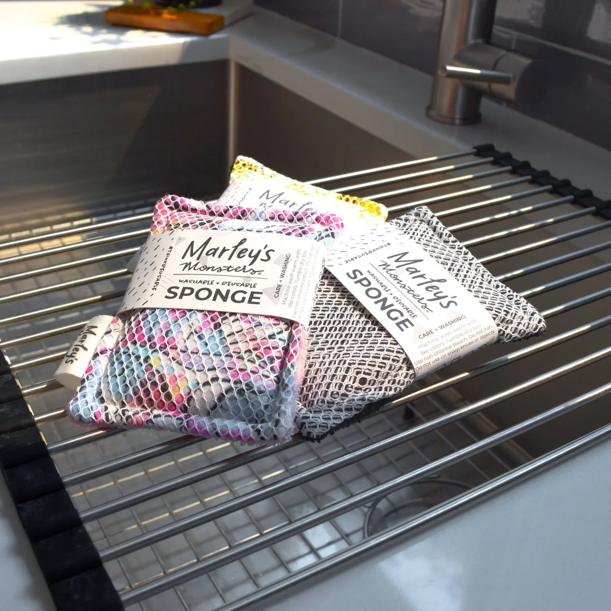 Reusable washable sponge by Marley's Monsters, showing a soft, eco-friendly cleaning sponge with a textured surface.