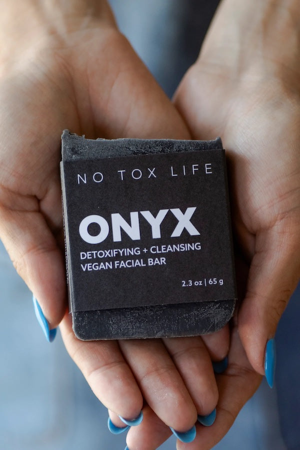 No Tox Life ONYX Facial Cleansing Bar with black soap and natural ingredients, shown in a close-up image.