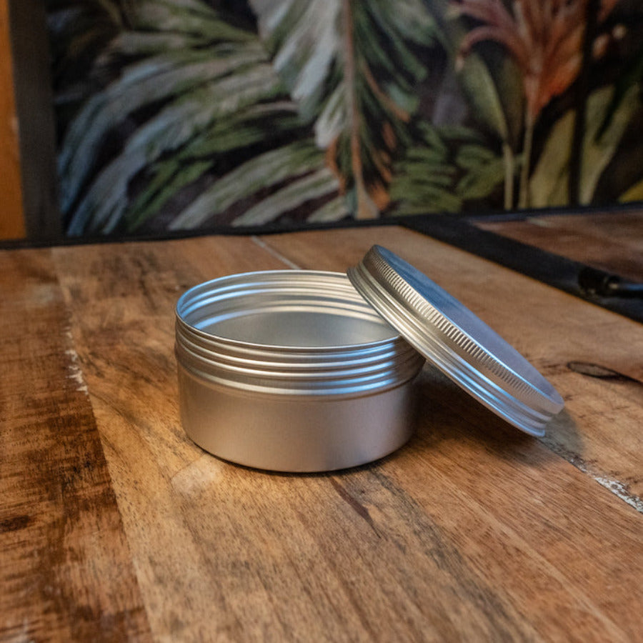 Reusable aluminum circular storage tin by OTB Refills, with a smooth metallic finish and compact round design for storage.