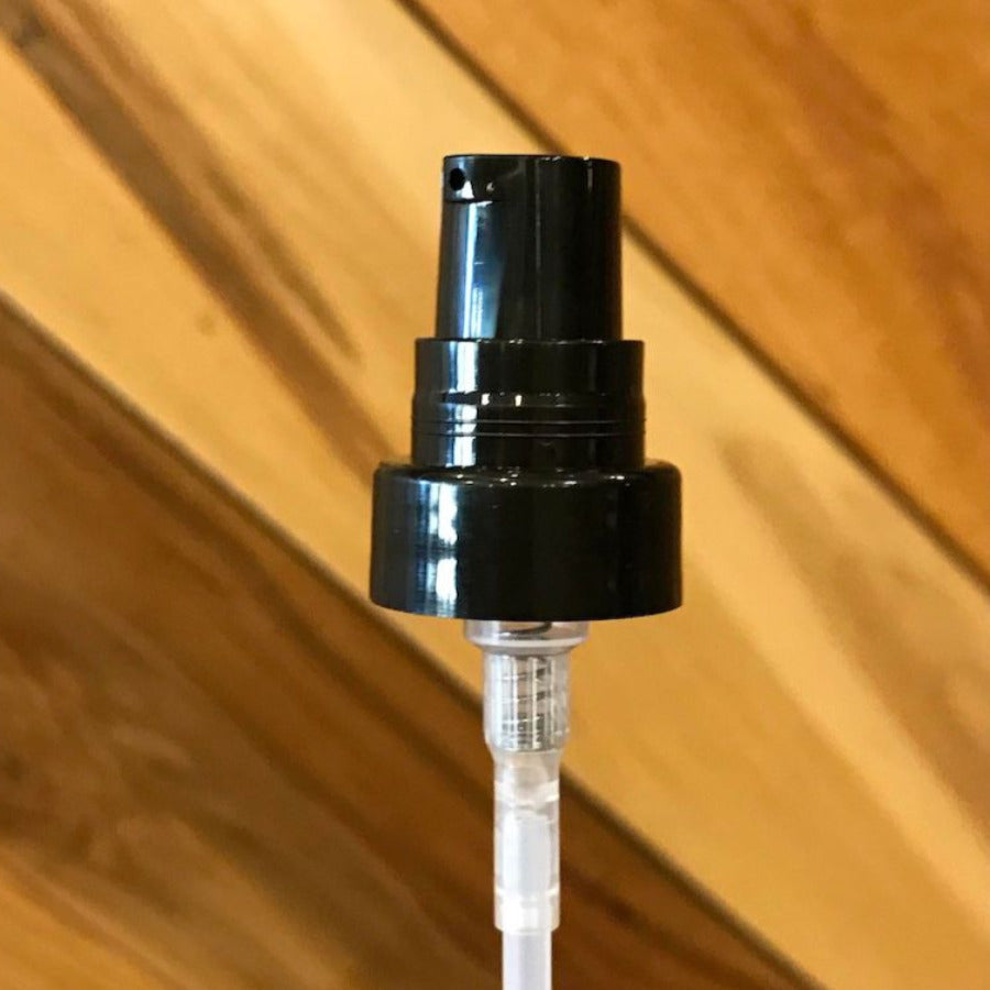 Small lotion treatment pump from Premium Vials fitting 4 oz bottles, with a sleek black pump and clear plastic bottle.