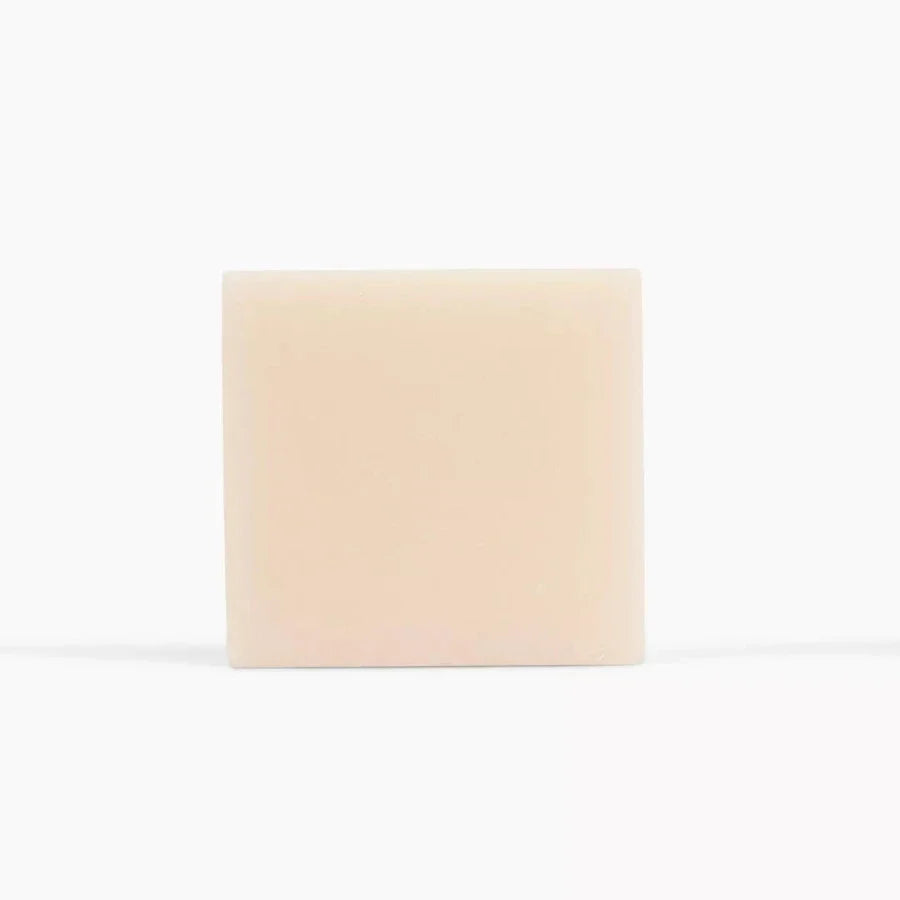 Spinster Sisters oatmeal, milk, and honey sugar scrub bar showing its raw, textured surface with natural ingredients.