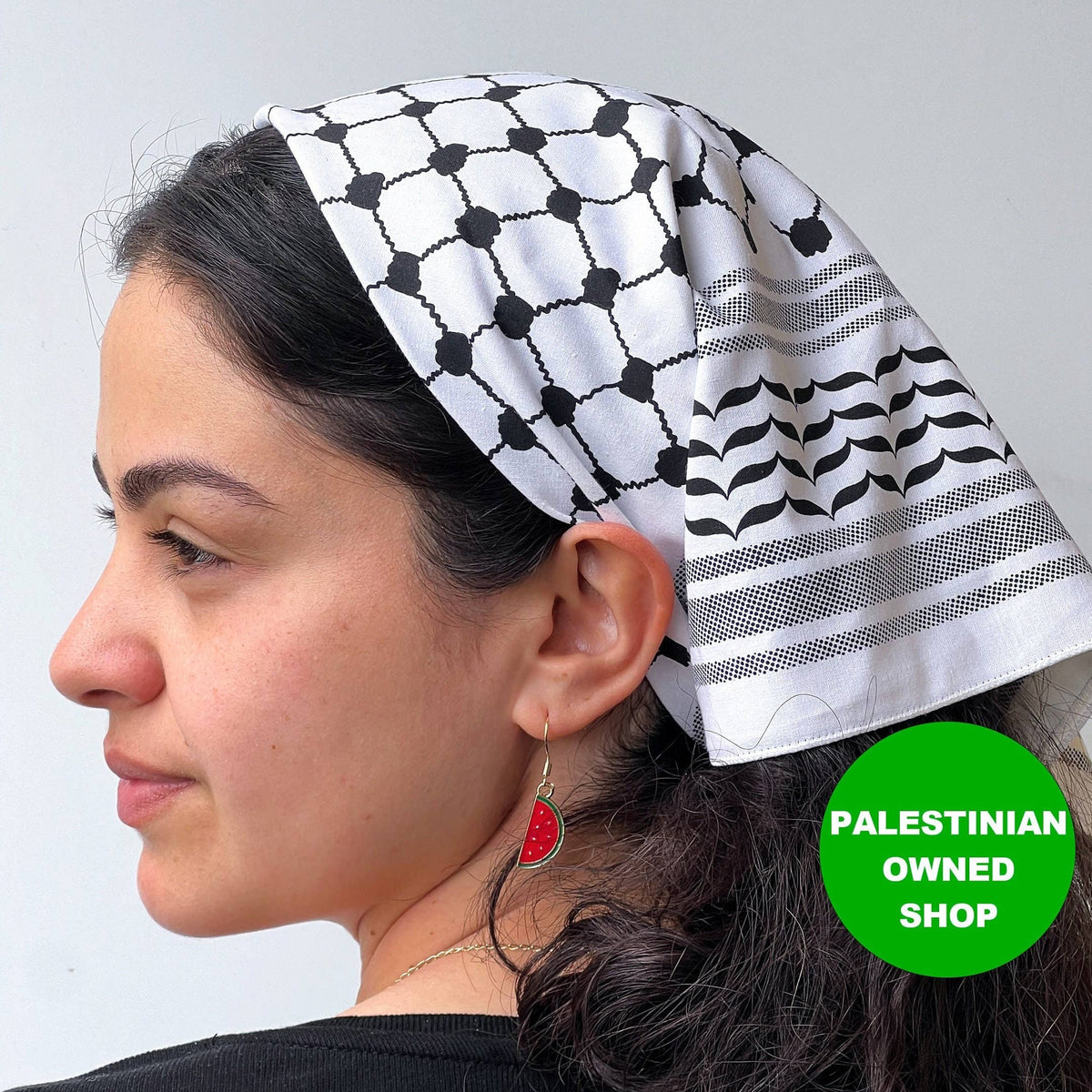 Stitch4pali 100% cotton keffiyeh bandana with traditional black and white geometric pattern, worn as a versatile head or neck accessory.
