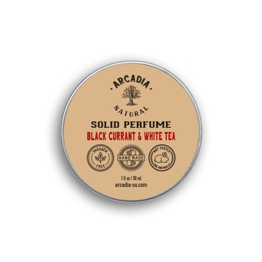 Natural solid perfume by Arcadia Naturals shown in a sleek, round container with a smooth, creamy texture and minimalistic design.
