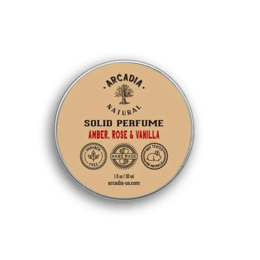 Natural solid perfume by Arcadia Naturals with a sleek black container and a clear lid, showcasing the elegant fragrance product.