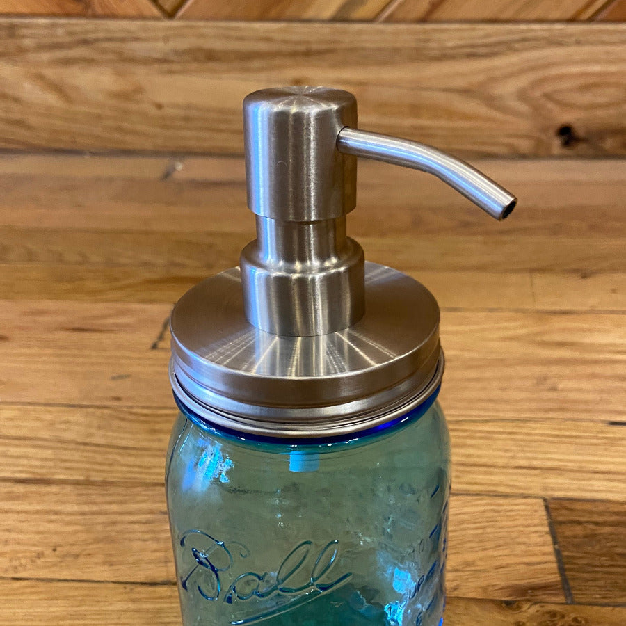 One Dream Design regular mouth mason jar soap and lotion pump attached to a clear glass jar.