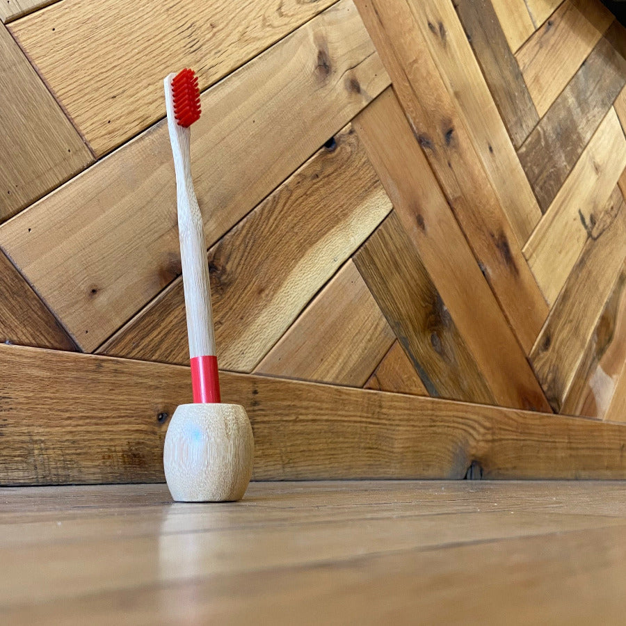 OTB Refills bamboo toothbrush stand holding a toothbrush, showcasing eco-friendly bathroom storage.
