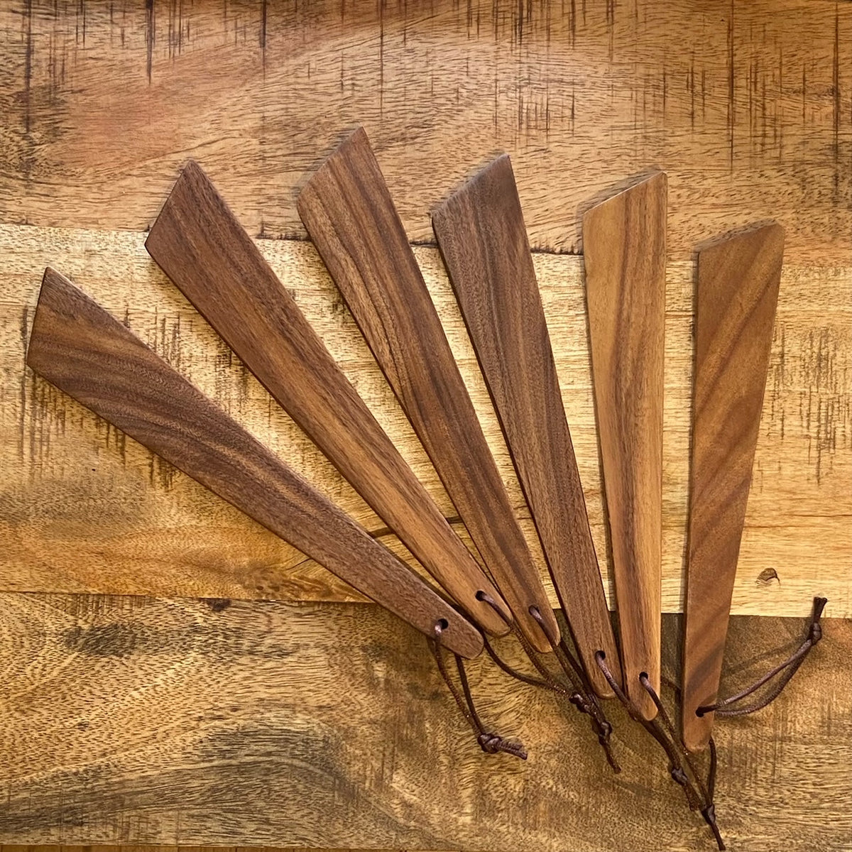 OTB Refills wood pan scraper with a sturdy wooden handle and metal blade for easy cleaning and scraping.