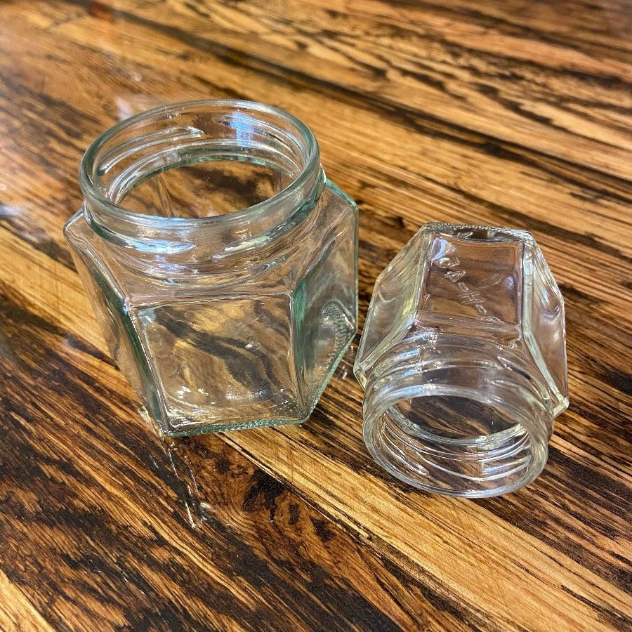 Set of Nakpunar hexagon glass jars with clear glass lids, ideal for storage and organization.
