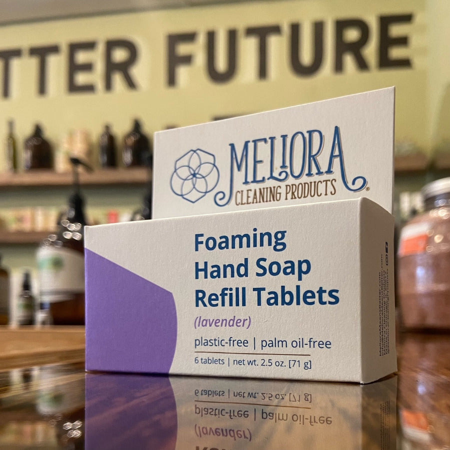 Meliora foaming hand soap refill tablets in a clear container, ready for dispensing into a foaming soap dispenser.