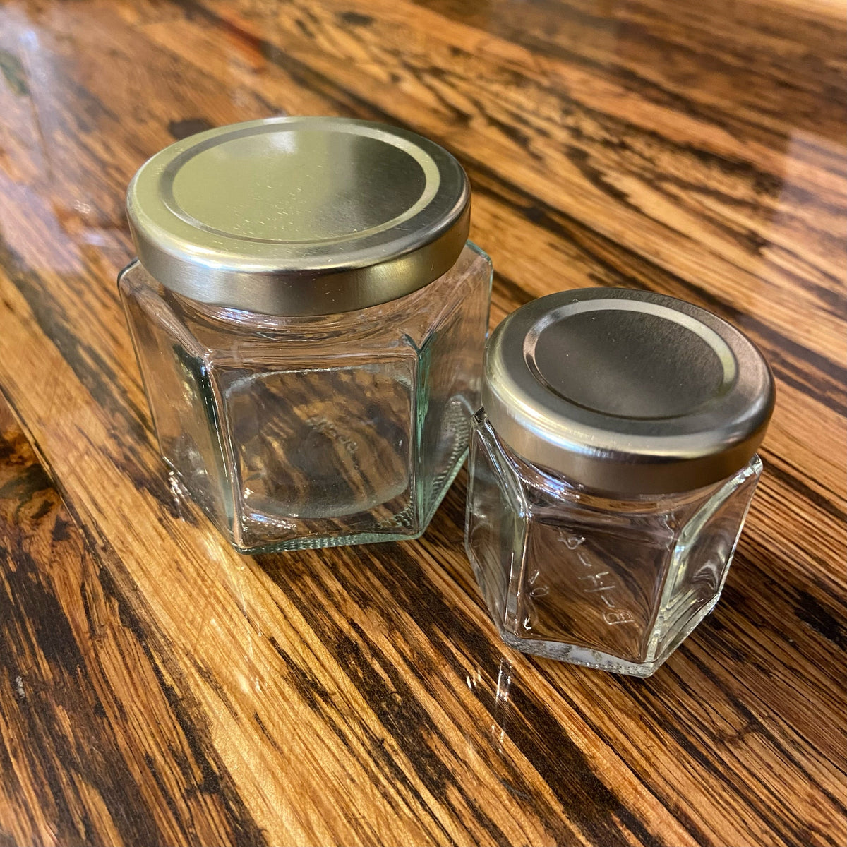 Nakpunar hexagon glass jars with clear, geometric design, perfect for storage or decorative use.